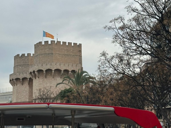 a passenger bus that is parked on the side of a building