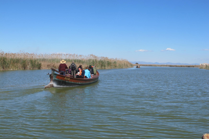 a group of people in a boat on a body of water