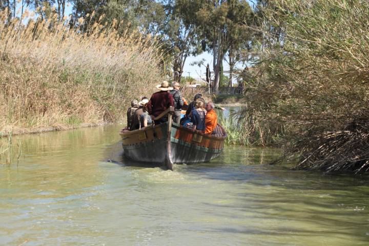 a man riding a elephant in the water
