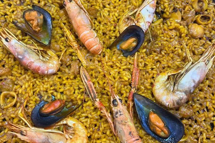 Seafood paella with shrimp, mussels, and rice in a pan.