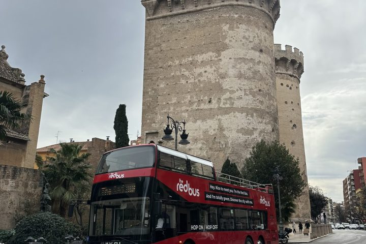 a double decker bus driving down a street
